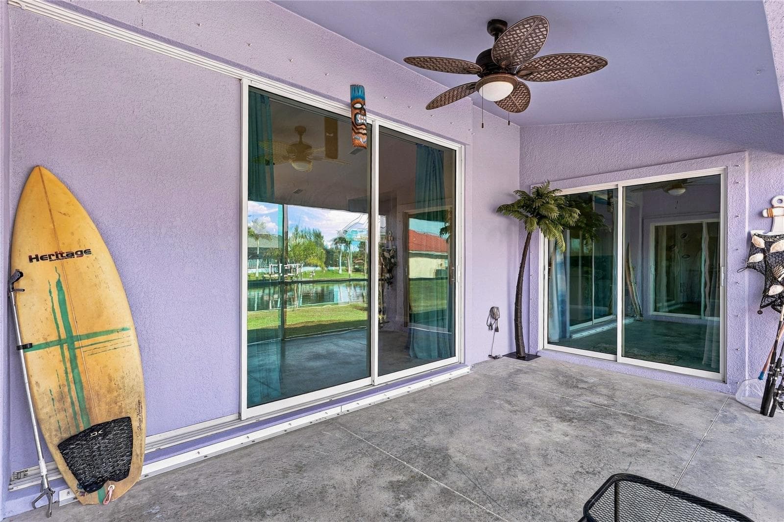 VIEW 2 OF LANAI LOOKING IN TO THE LIVING ROOM AND PRIMARY BEDROOM. - 10554 LIVE OAK RD, PORT CHARLOTTE