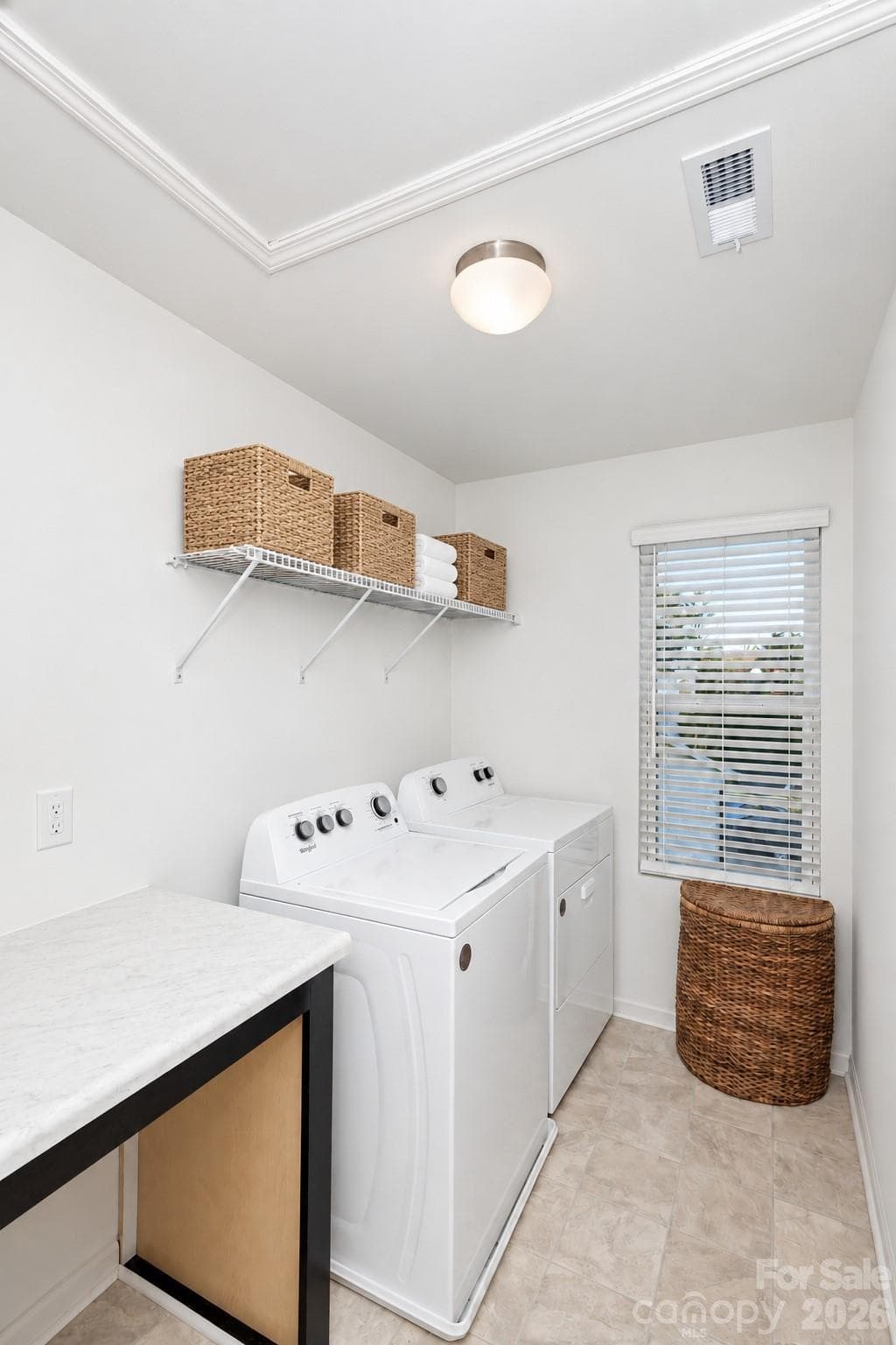 Large laundry room with folding table - 106 Stonewater Drive, Stanfield