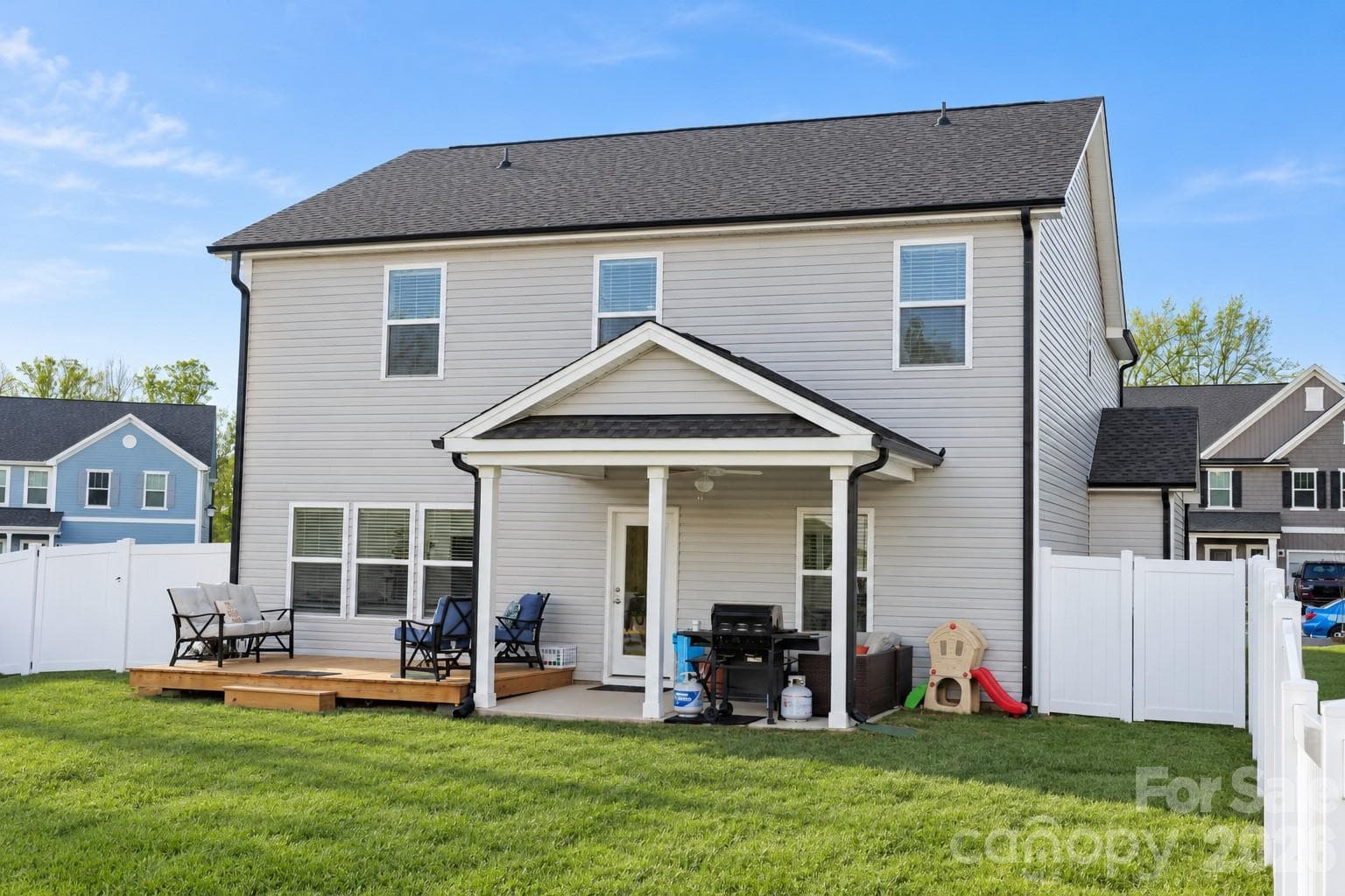 Relaxing covered patio with ceiling fan and attached deck - 106 Stonewater Drive, Stanfield