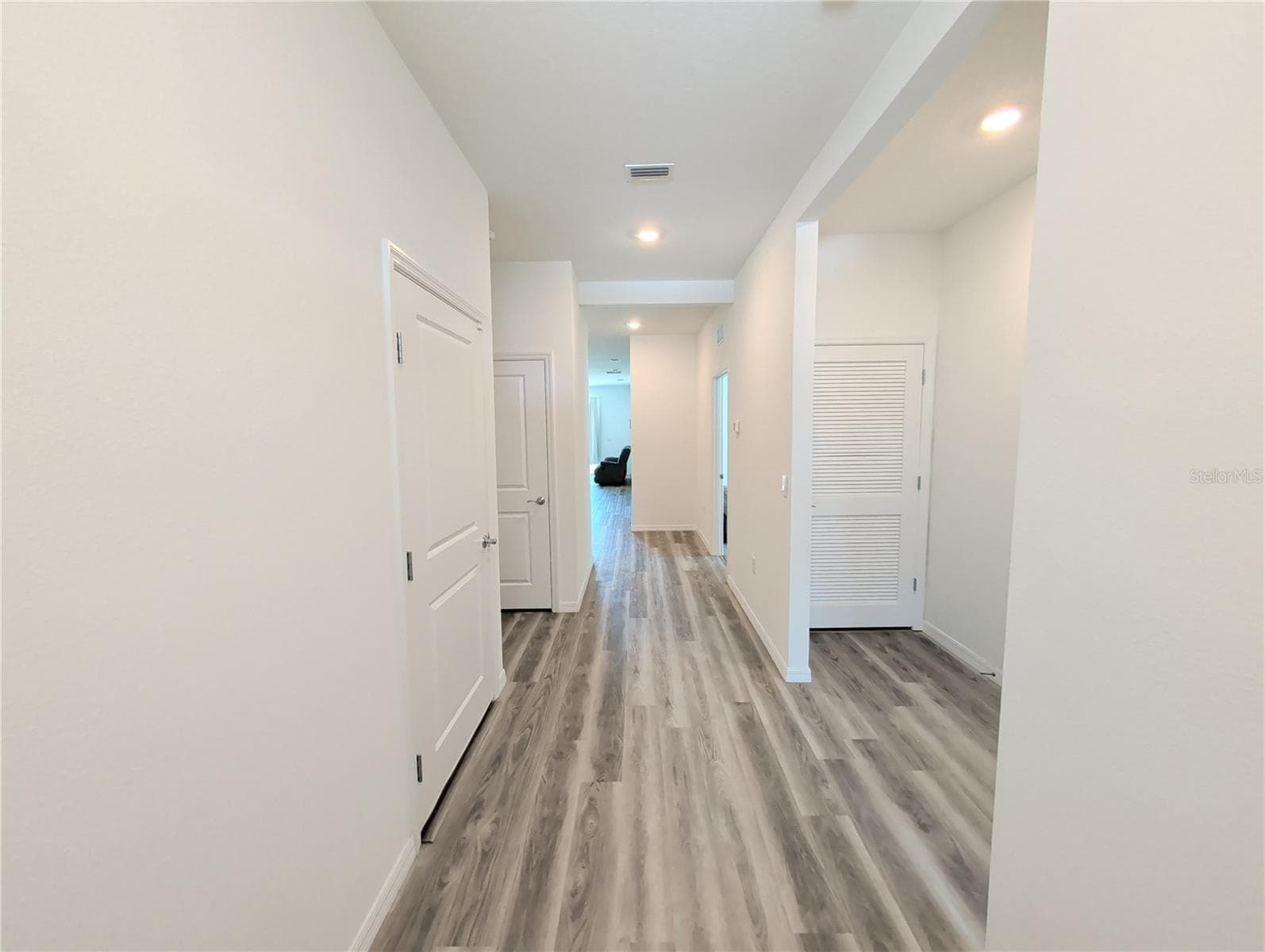 Entrance hallway. Garage door on L. 3rd Bedroom, 2nd bathroom, and Air handler closet on R - 4057 WESTWOOD FIELDS LOOP, PLANT CITY