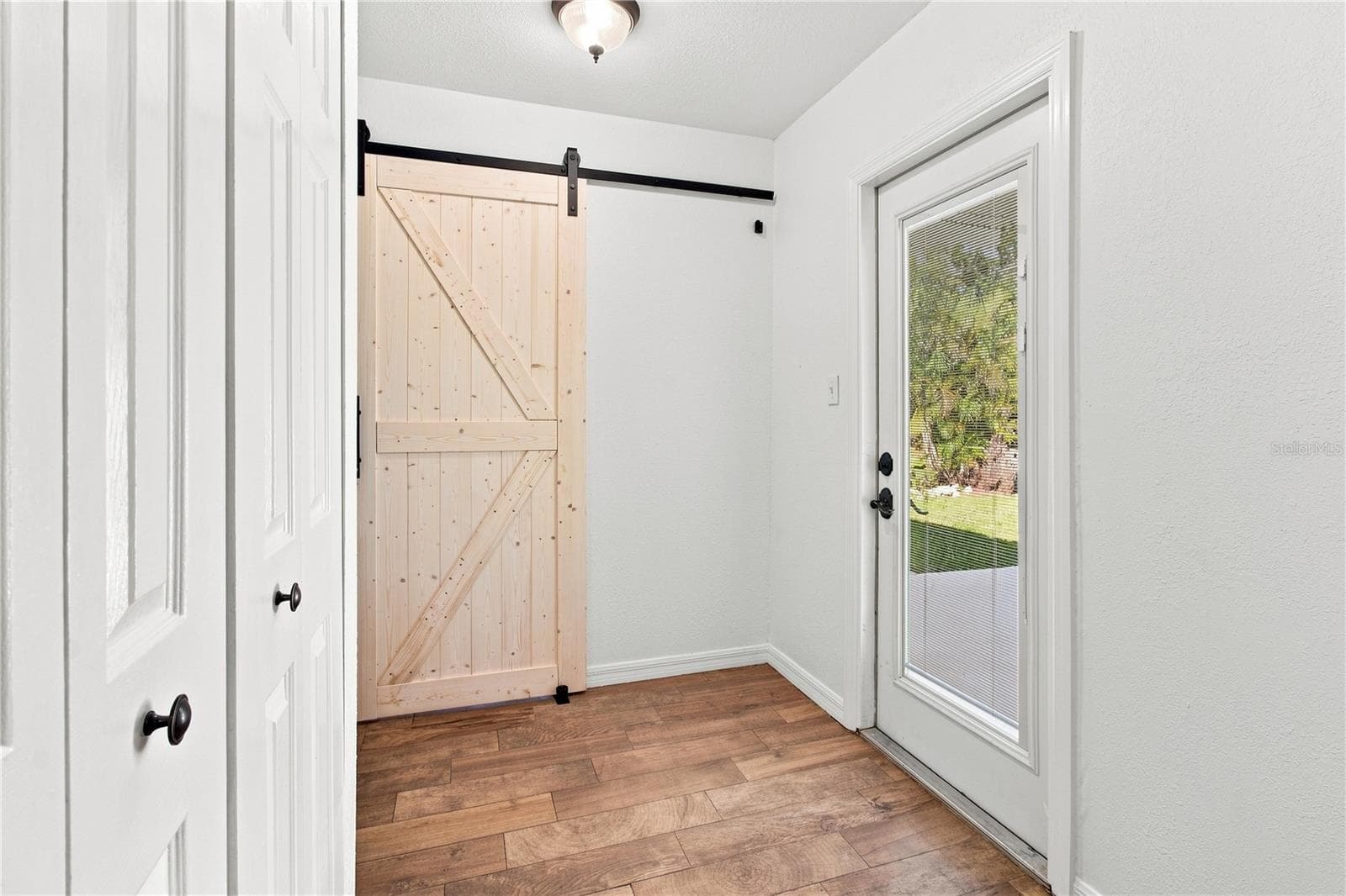 laundry room behind barn door - 1126 CARMELLA CIR, SARASOTA