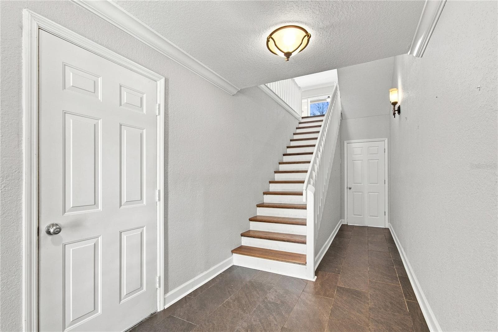 Deep garage and access to the waterfront patio through these doors. - 152 117TH AVE, TREASURE ISLAND
