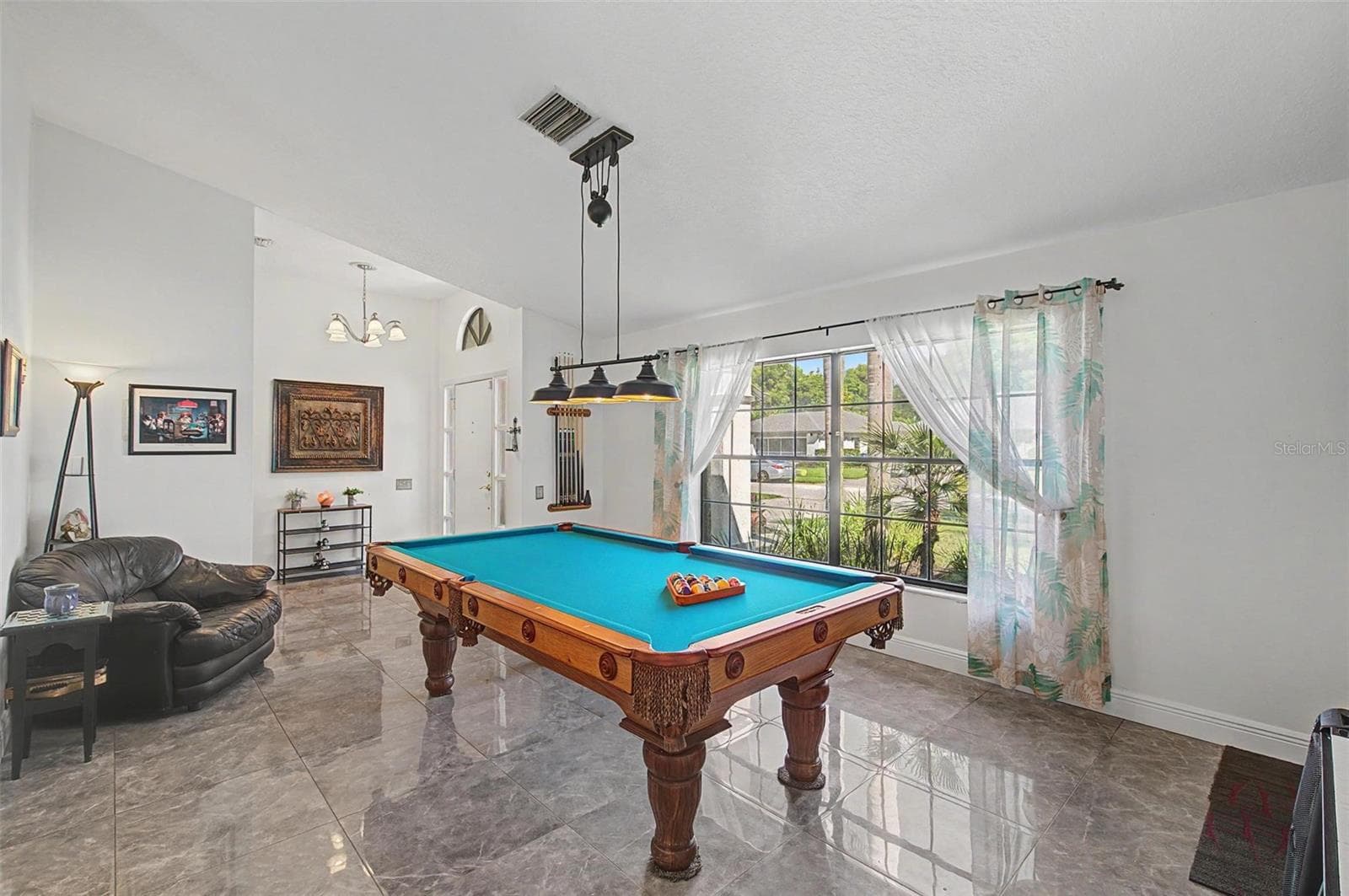 Front room from front door. Pool table has the required amount of space around the table to play. - 8612 BRAXTON DR, HUDSON