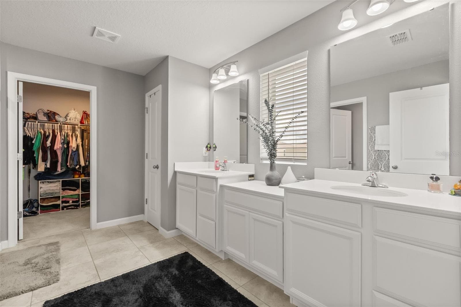 Primary bath with  double vanities, linen closet,  & second walk-in closet. - 1596 EUCALYPTUS WAY, DAVENPORT