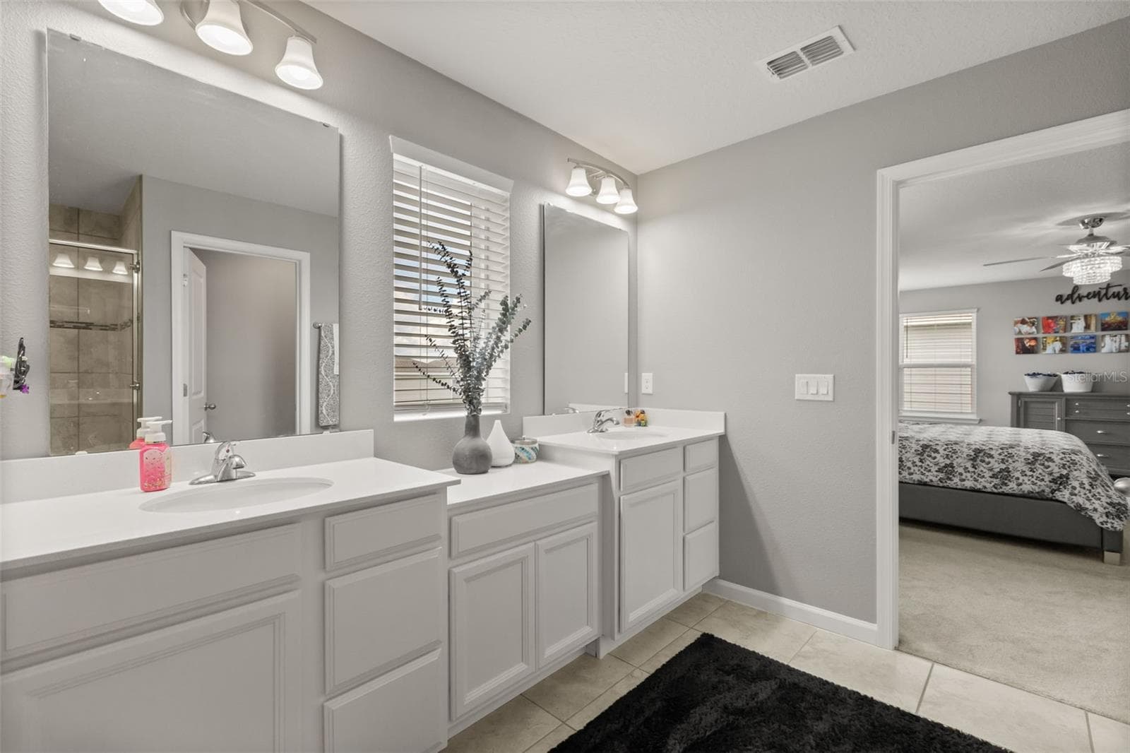 Primary bath features dual vanities with solid-surface tops. - 1596 EUCALYPTUS WAY, DAVENPORT