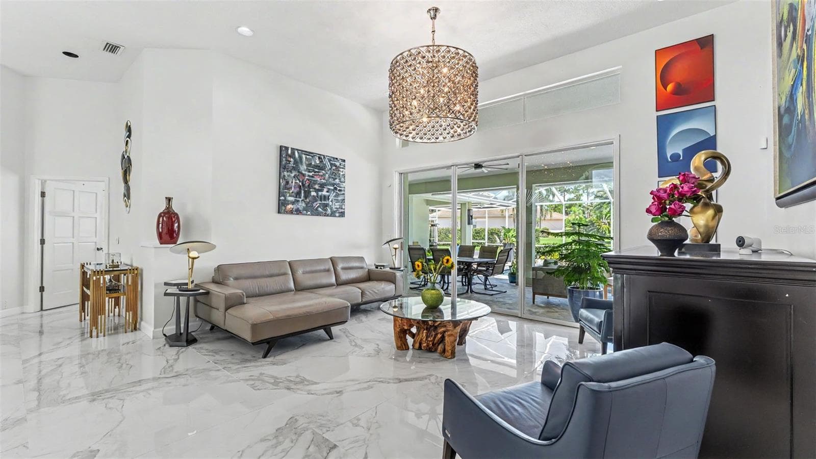 The Living Room has a nice airy feeling and features volume ceilings, tile floors, sliders leading out to the pool area - 3417 BARLEY CT, LAKELAND