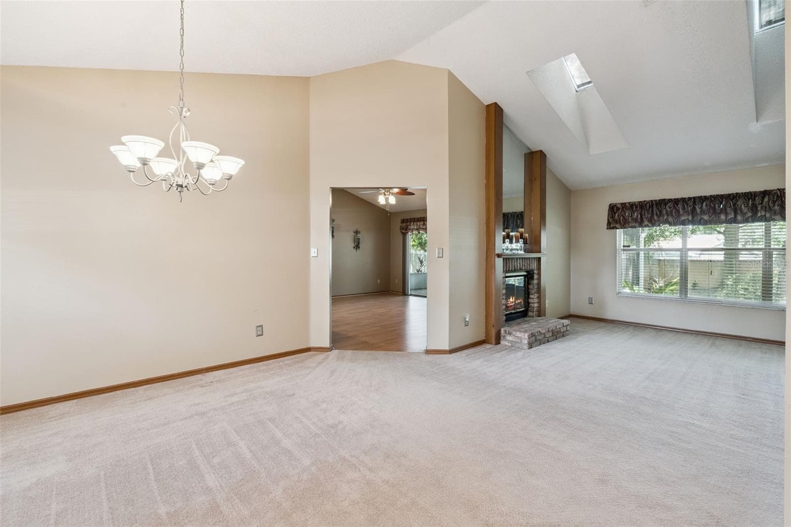 A sneak peak view of the living room and wood burning fireplace. - 288 RINGWOOD DR, WINTER SPRINGS