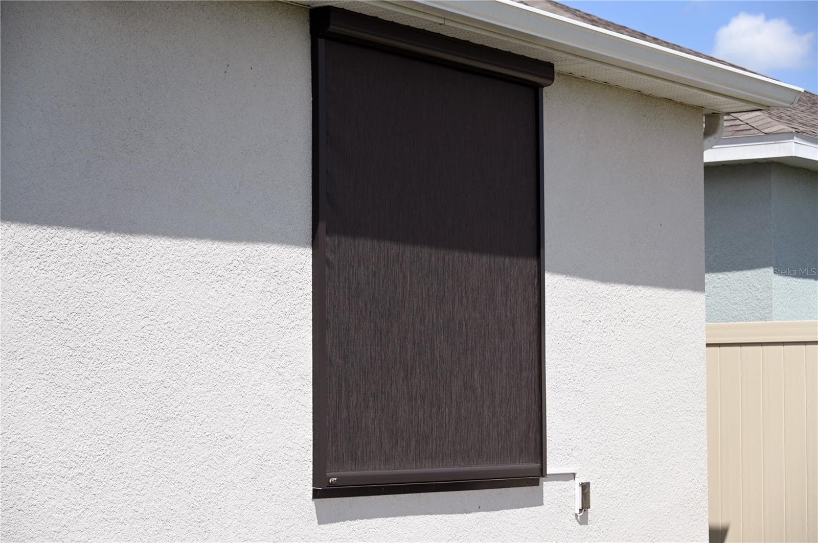 Motorized screen covering master bedroom window - 4104 GOOSEBERRY TRL, KISSIMMEE