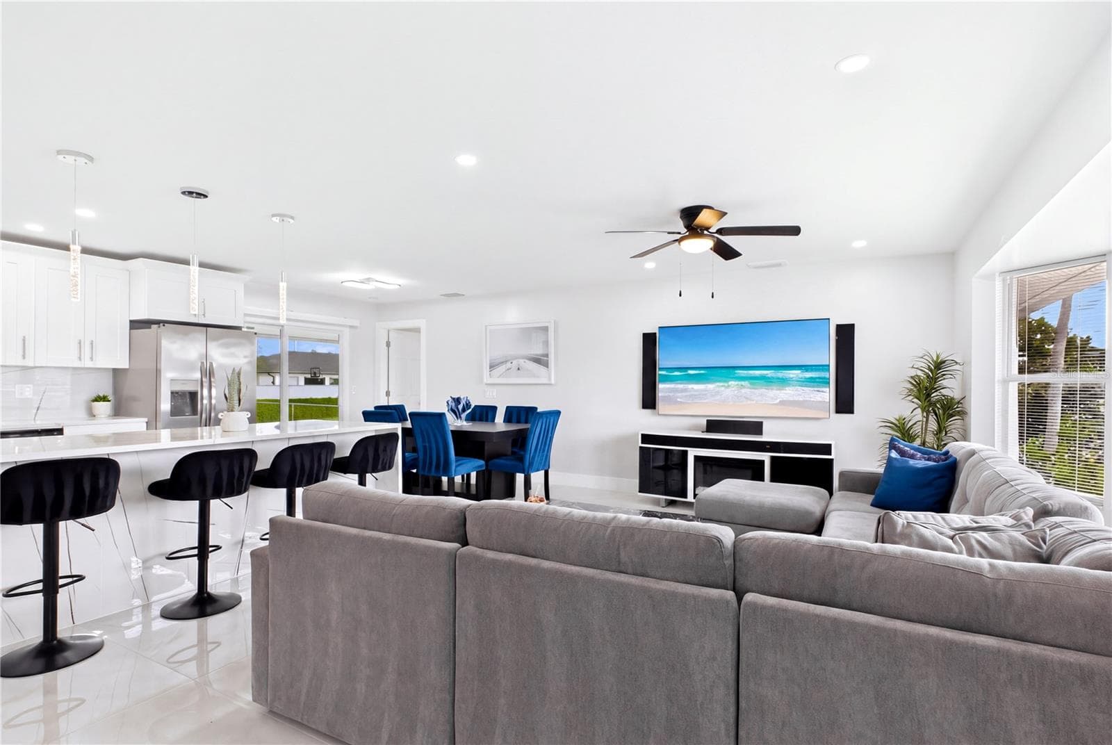 Spacious OPEN-CONCEPT living room is bright, modern & designed for comfortable everyday living. - 256 SE SANTA BARBARA PL, CAPE CORAL