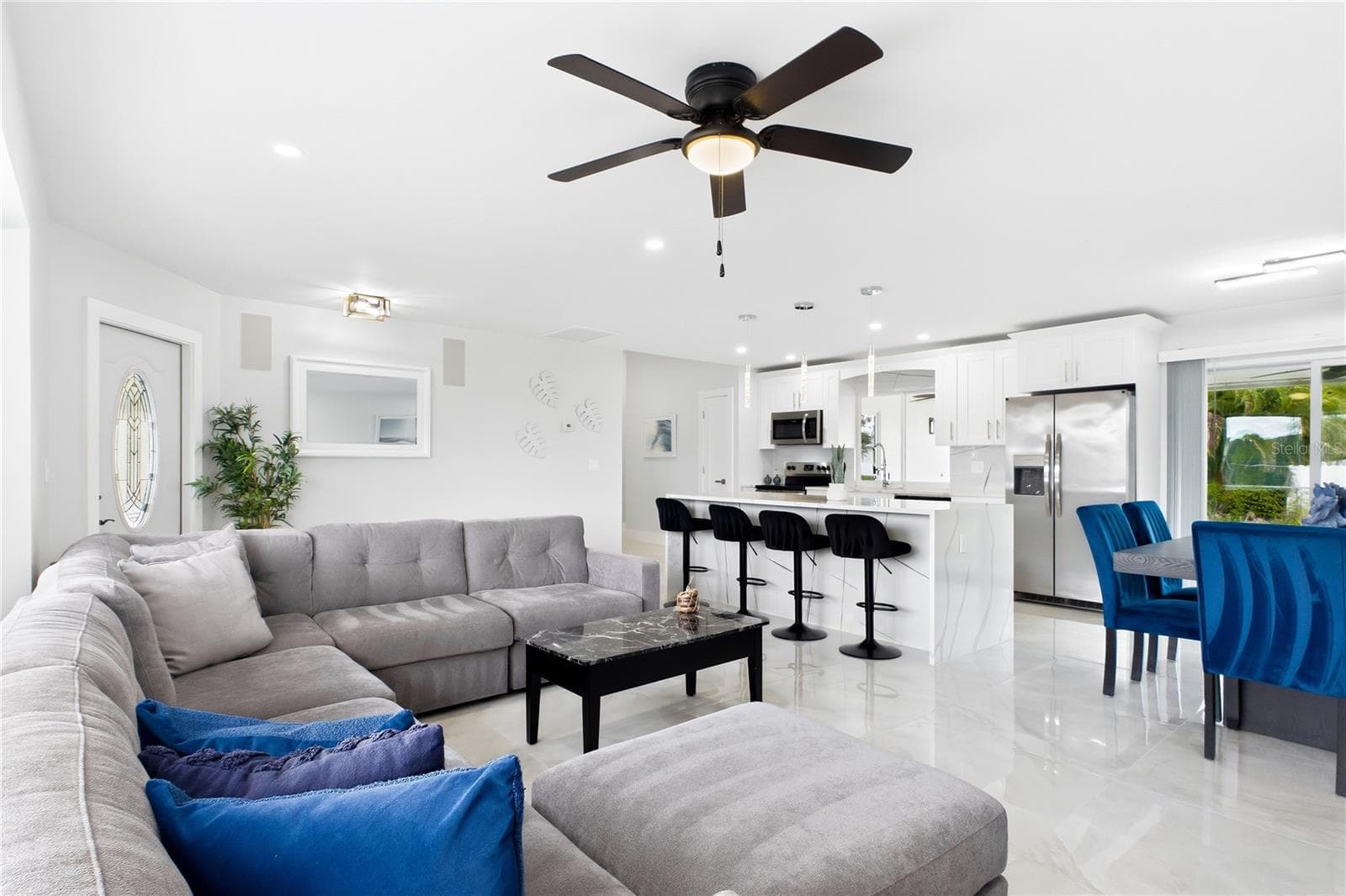 The OPEN-CONCEPT living, dining & kitchen areas are filled w/ natural light, creating an inviting space for everyday living & entertaining. - 256 SE SANTA BARBARA PL, CAPE CORAL