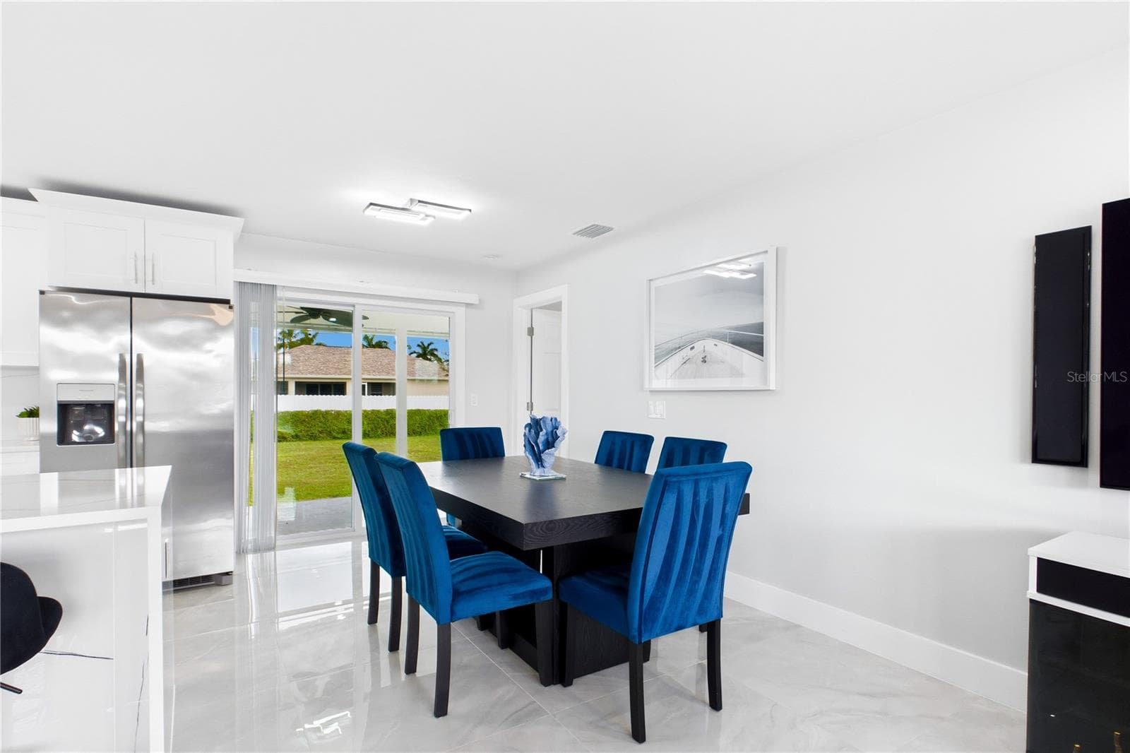 Bright DINING AREA flows seamlessly between the kitchen & living room for effortless everyday living & entertaining. - 256 SE SANTA BARBARA PL, CAPE CORAL