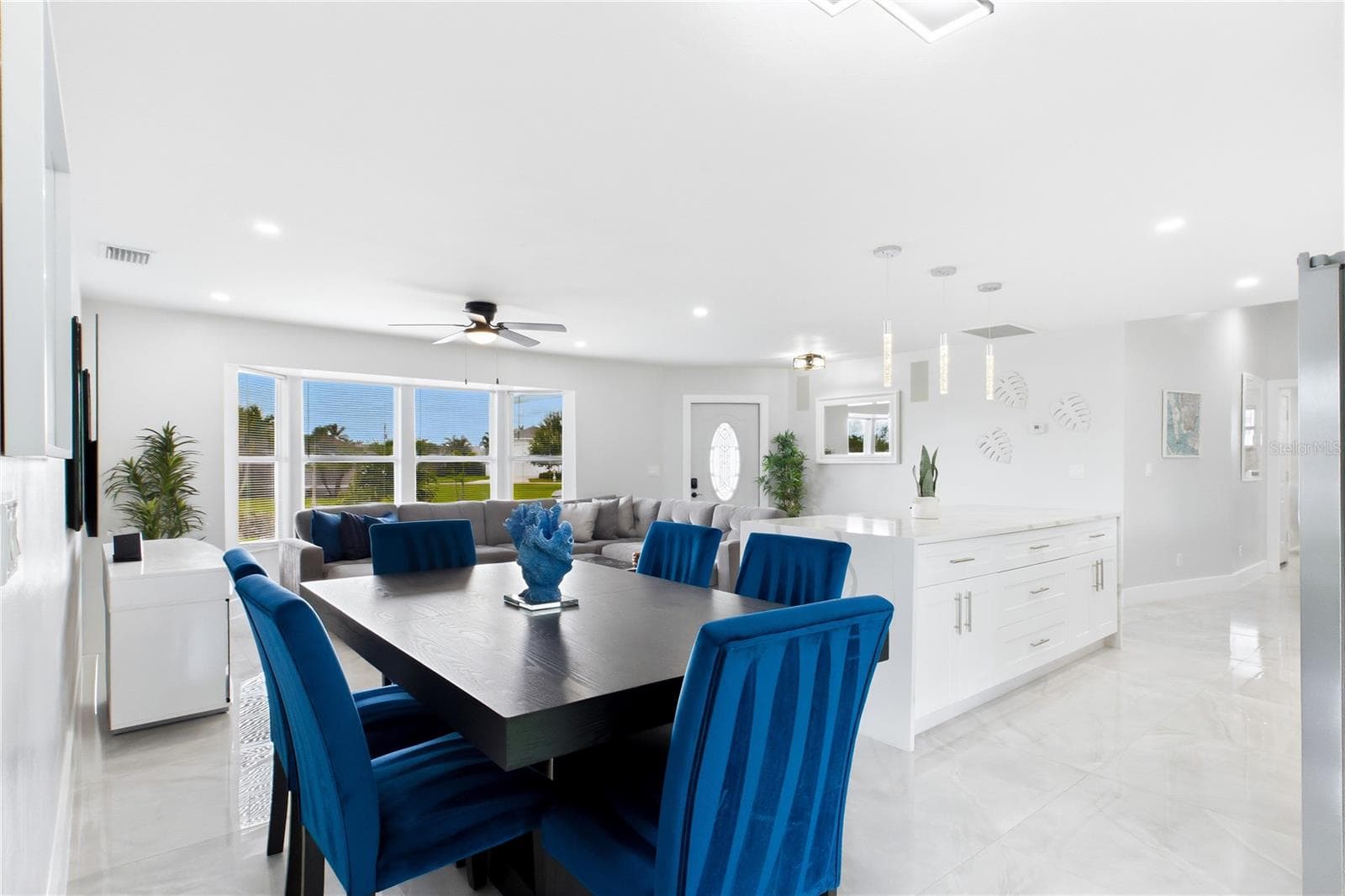 The OPEN-CONCEPT layout provides plenty of space for gathering while remaining connected to the heart of the home. - 256 SE SANTA BARBARA PL, CAPE CORAL