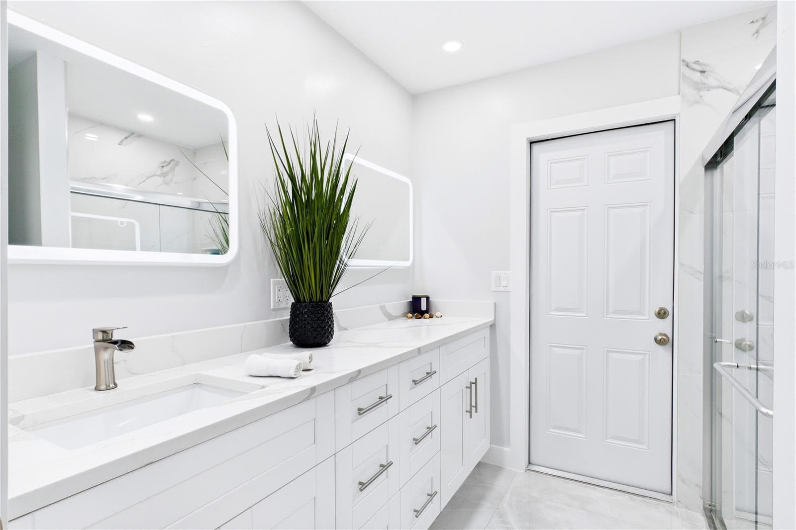 The beautifully RENOVATED POOL BATHROOM offers convenient access from the outdoor living area, perfect for future pool days & entertaining. - 256 SE SANTA BARBARA PL, CAPE CORAL