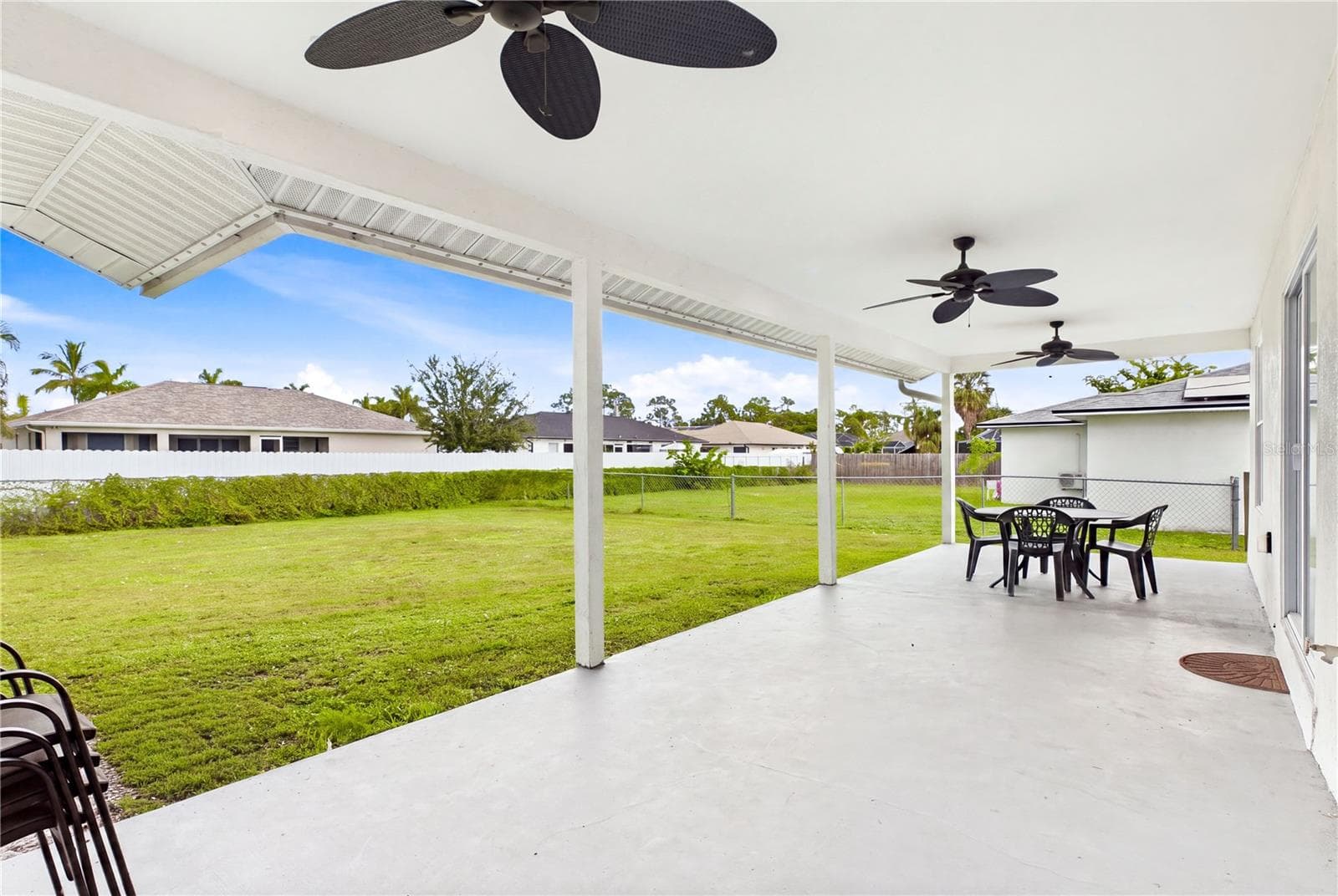 Outside to an EXPANSIVE COVERED LANAI w/ multiple ceiling fans, perfect for outdoor dining, grilling & relaxing. - 256 SE SANTA BARBARA PL, CAPE CORAL
