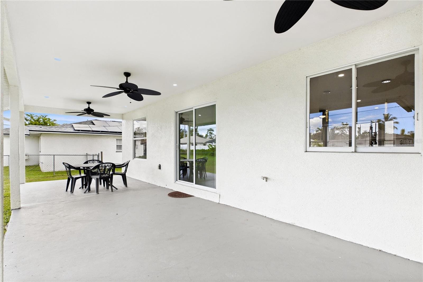 EXPANSIVE COVERED PATIO w/ multiple ceiling fans creates the perfect outdoor living space for dining, grilling, entertaining & enjoying the SWFL weather year-round. - 256 SE SANTA BARBARA PL, CAPE CORAL