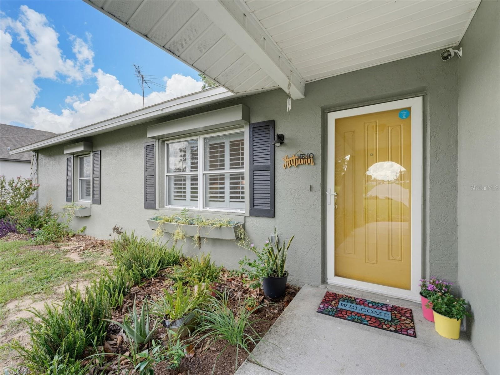 CHEERFUL YELLOW FRONT ENTRANCE WITH GLASS STORM DOOR FOR EXTRA LIGHT - 11113 NORVELL RD, SPRING HILL