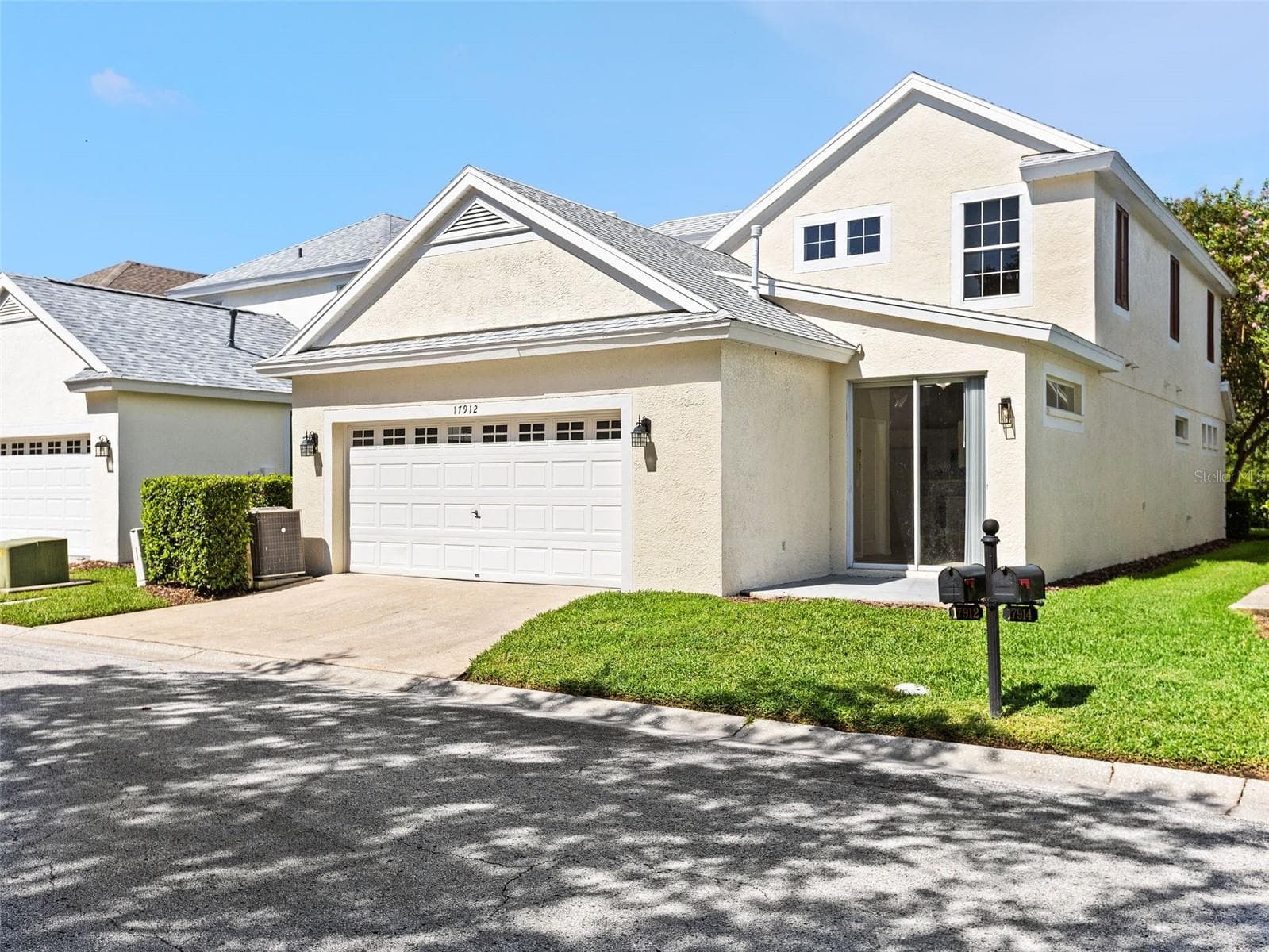 Back garage and sliding glass entrance - 17912 HAVENVIEW LN, LUTZ