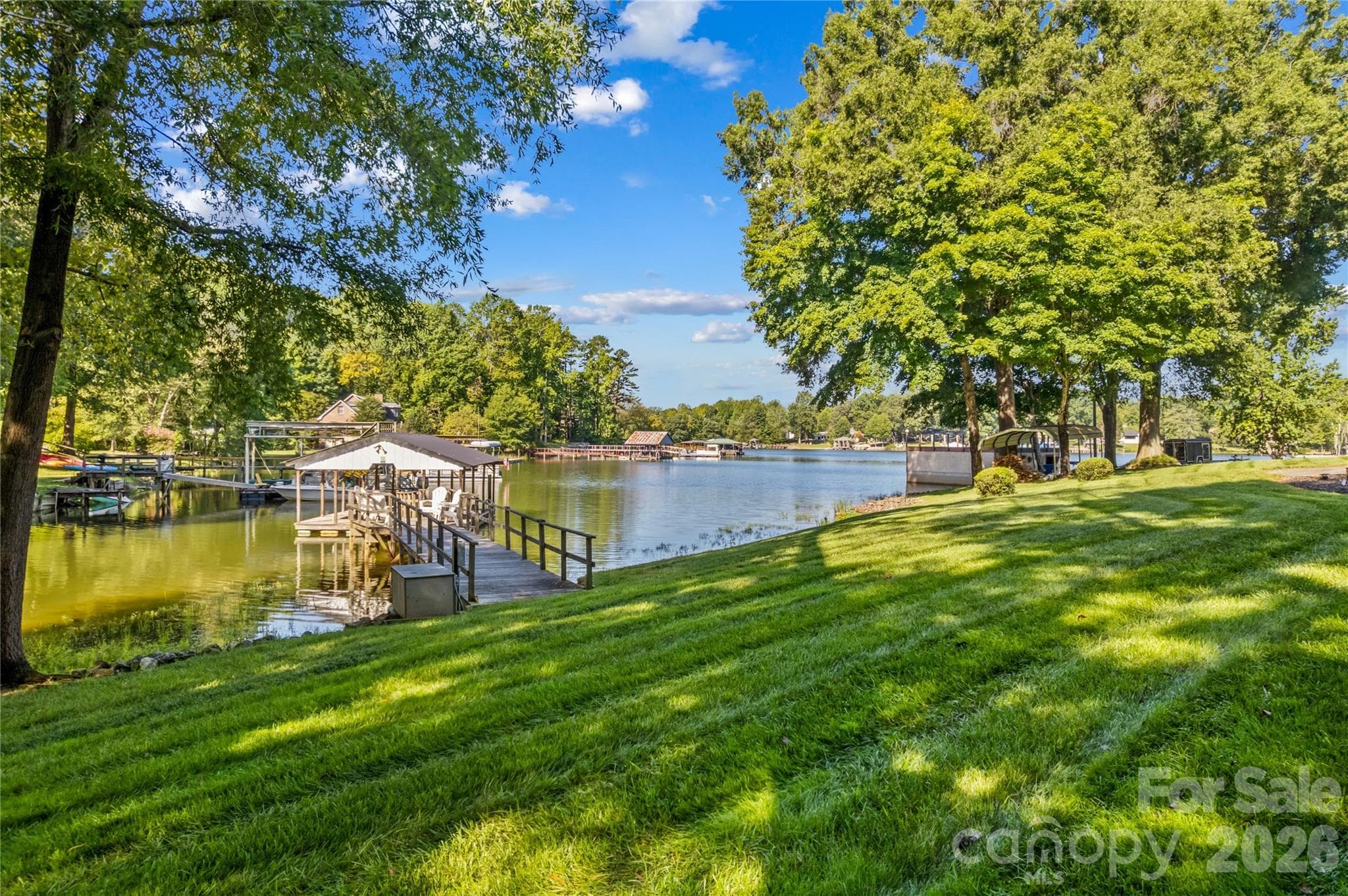 View of the pier with covered boat slip - 150 Shady Cove Drive, Troutman
