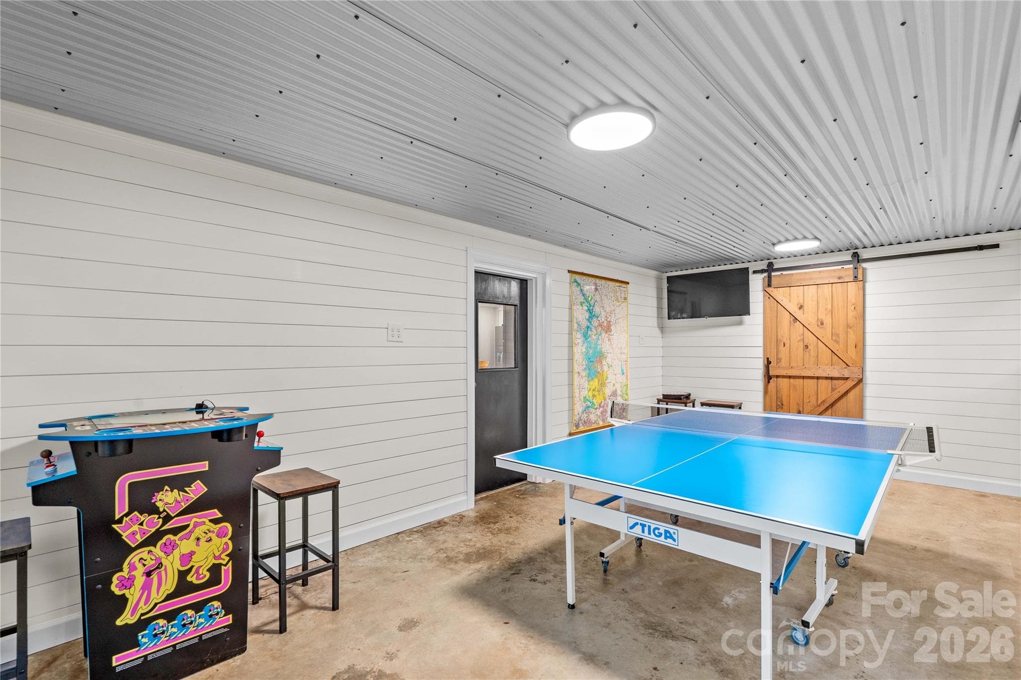 Recreation room with laundry room behind the barn door - 150 Shady Cove Drive, Troutman