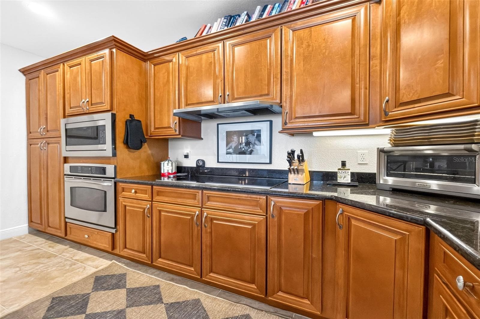An exceptionally well- designed kitchen features induction cooktop, wall oven and microwave - 95 N MARION CT #135, PUNTA GORDA