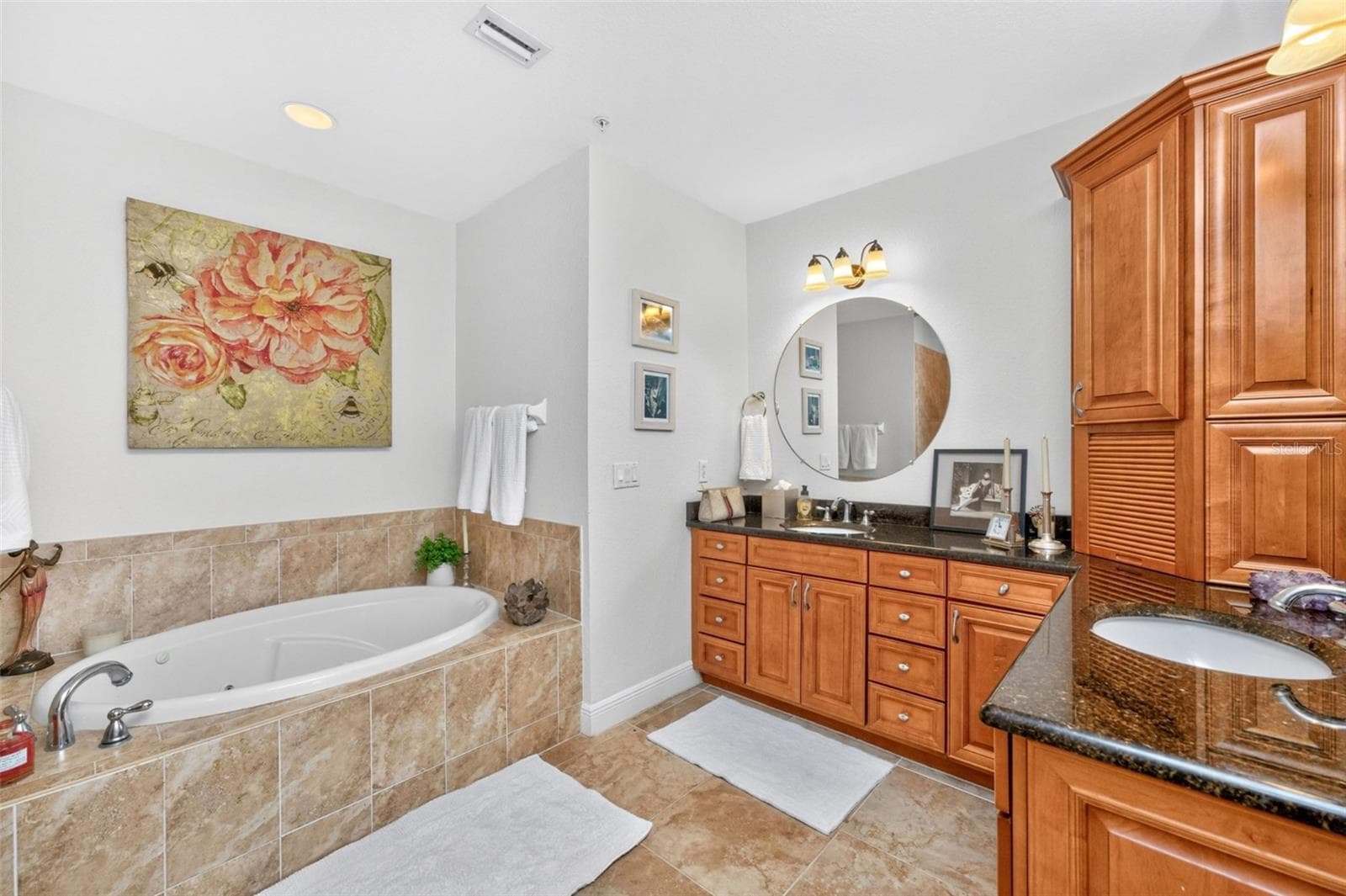 Dual vanities, jetter tub create a spa like vibe finished with solid wood soft cabinetry with linen closet. - 95 N MARION CT #135, PUNTA GORDA