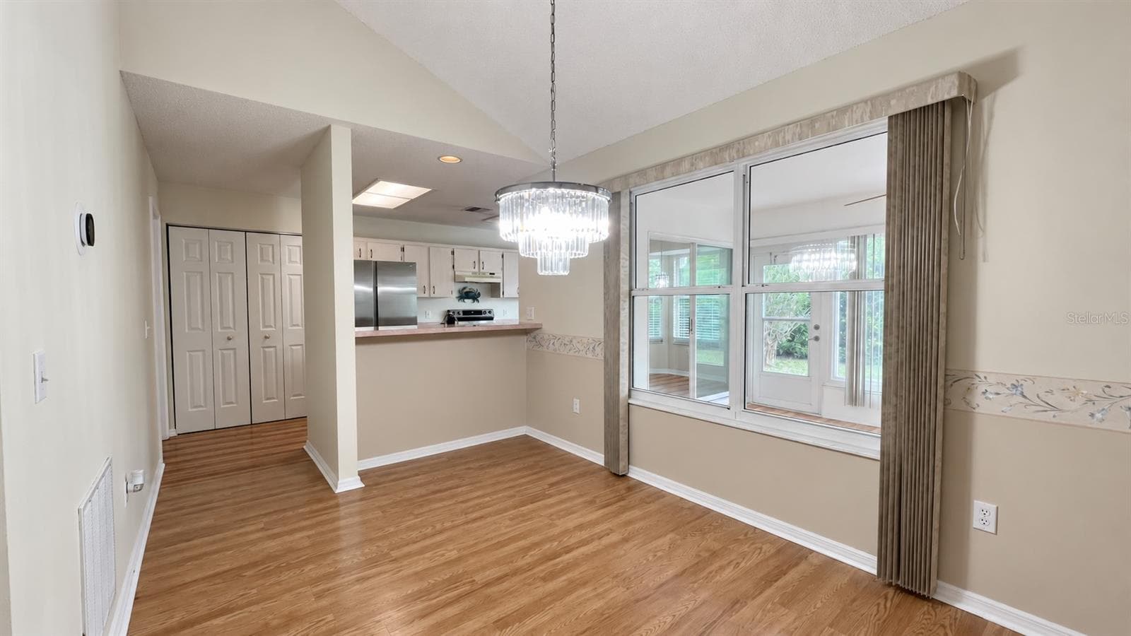 Dining room leading into the large kitchen and facing the enclosed lanai. - 6501 SW 84TH PLACE RD, OCALA