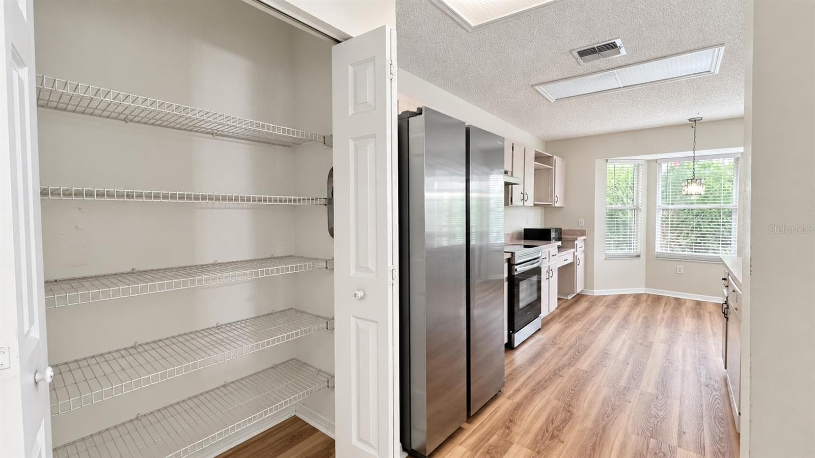Spacious pantry in the large kitchen facing the enclosed lanai and backyard. - 6501 SW 84TH PLACE RD, OCALA