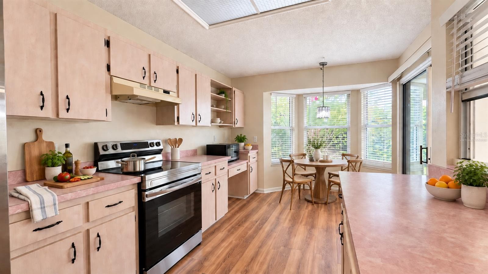 Large kitchen with breakfast room facing the backyard. Virtually staged. - 6501 SW 84TH PLACE RD, OCALA