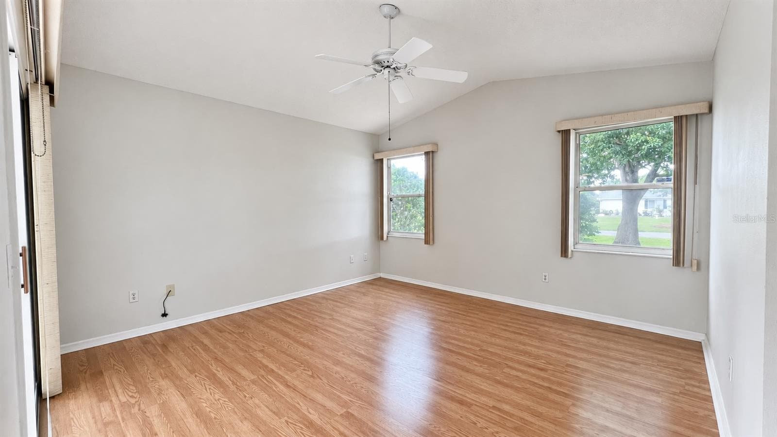 Master bedroom facing the side and lanai features large WIC and bath. - 6501 SW 84TH PLACE RD, OCALA