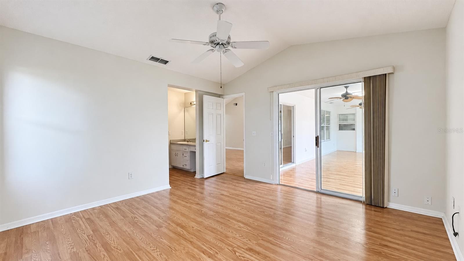 Master bedroom facing the side and lanai features large WIC and bath. - 6501 SW 84TH PLACE RD, OCALA