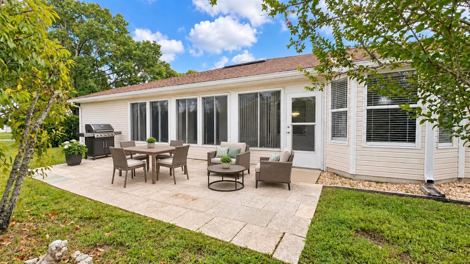 Large back patio with plenty of space to entertain and privacy. Virtually staged. - 6501 SW 84TH PLACE RD, OCALA