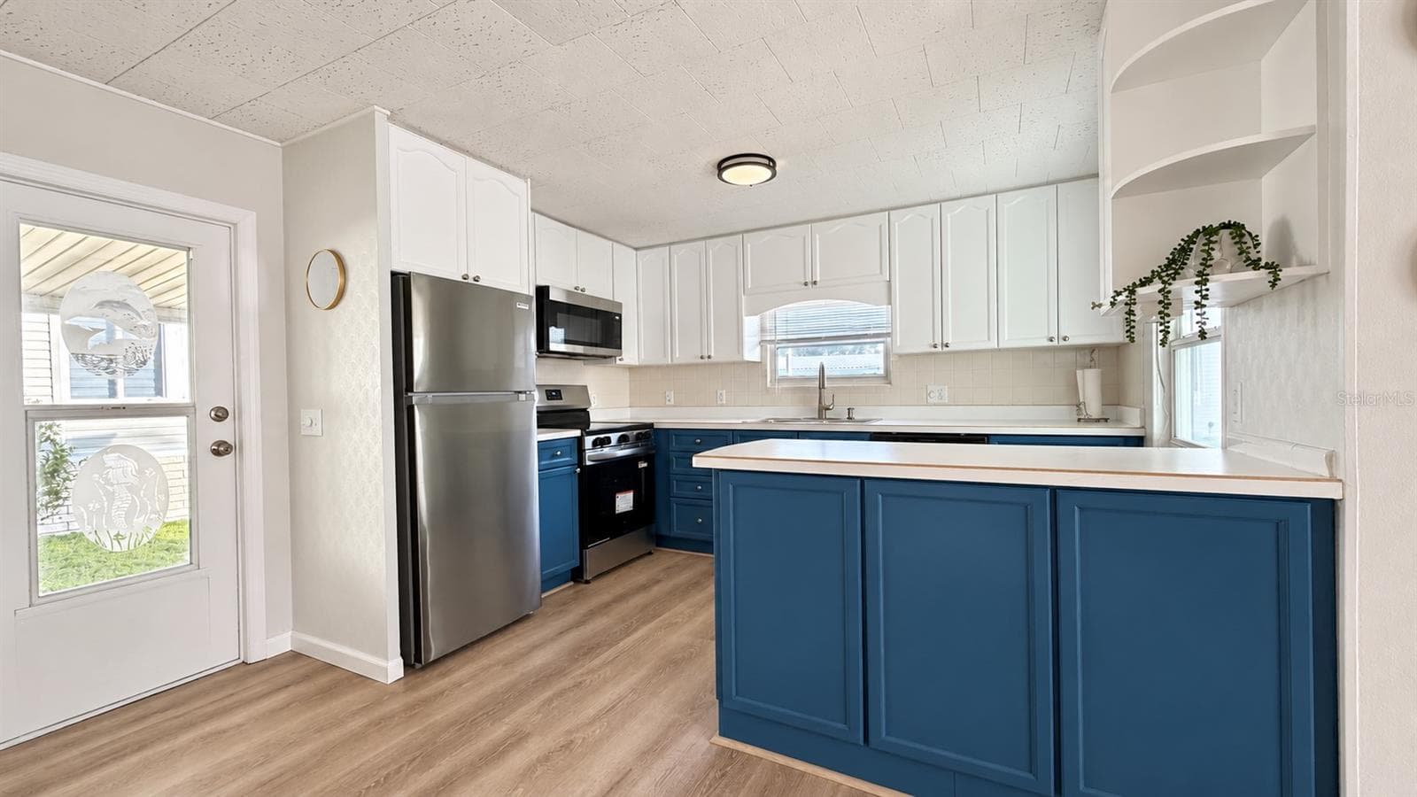 kitchen with island - 1100 BELCHER RD S #64, LARGO