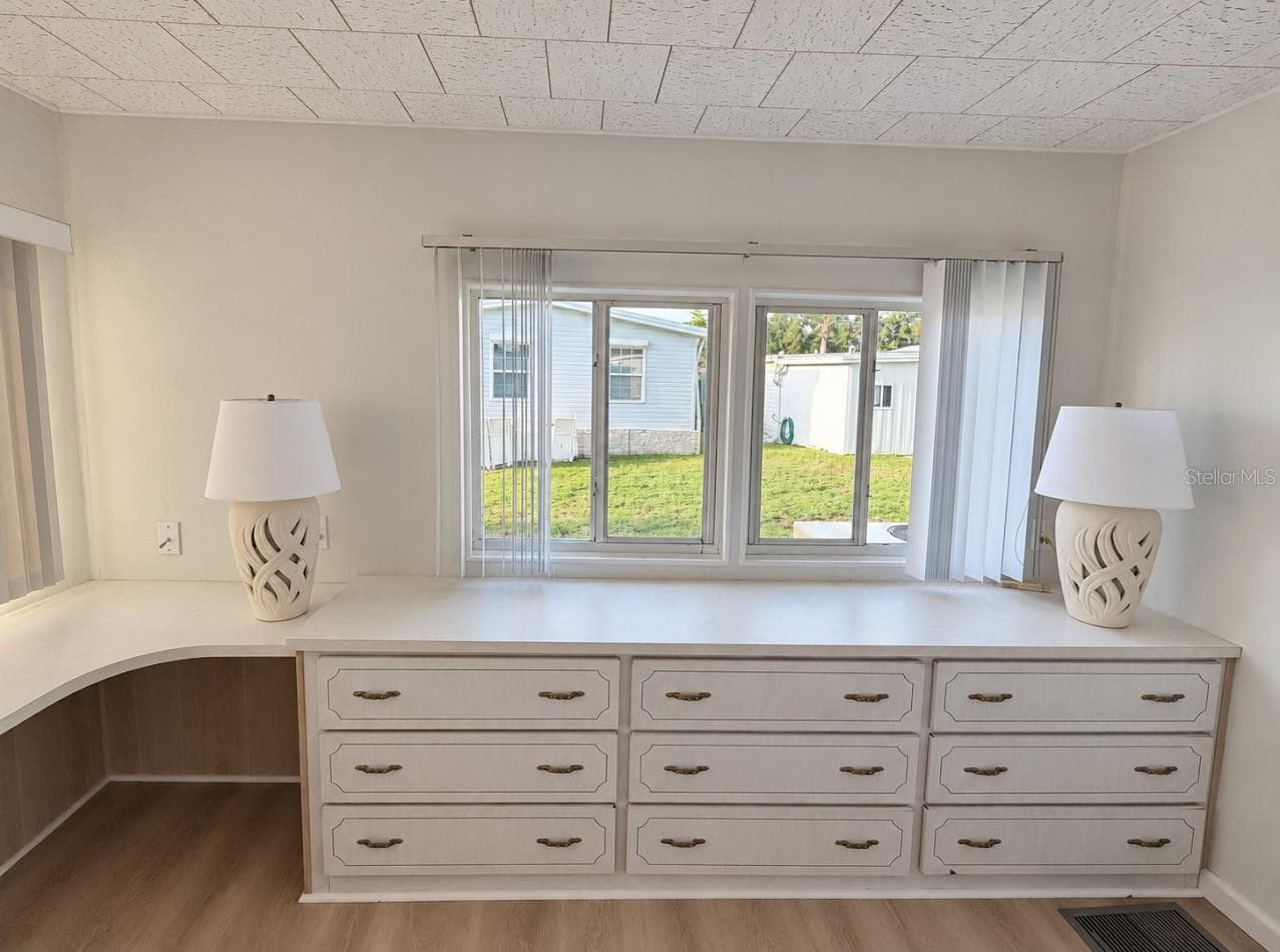 primary bedroom with built in dressers and vanity area - 1100 BELCHER RD S #64, LARGO