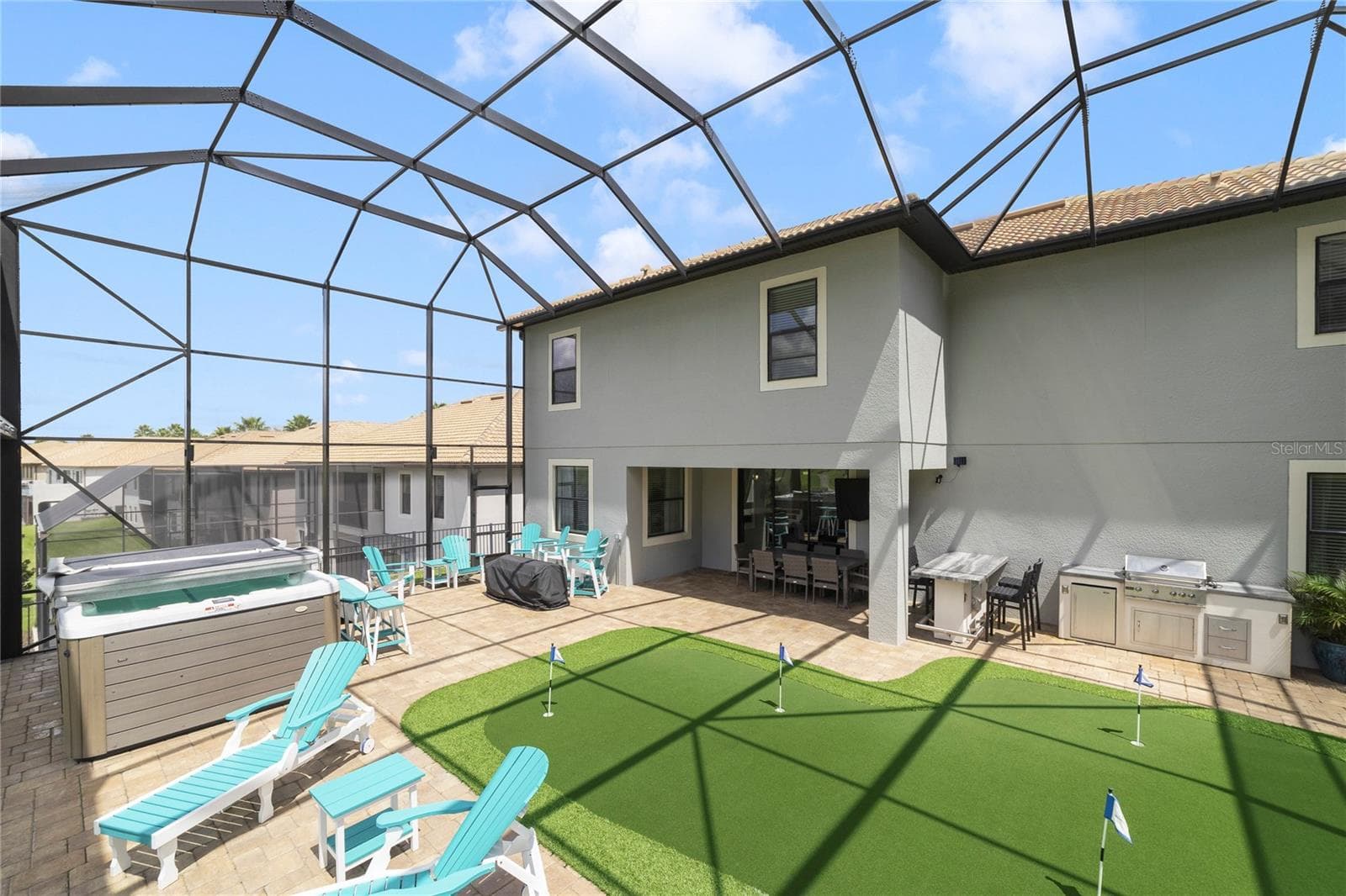 Lanai with putting green and swim spa - 1456 MICKELSON CT, DAVENPORT
