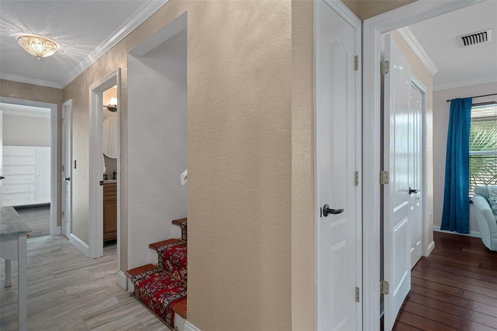 Hall to guest bedrooms and stairs to Primary suite level - 5517 TROPIC DR, NEW PORT RICHEY
