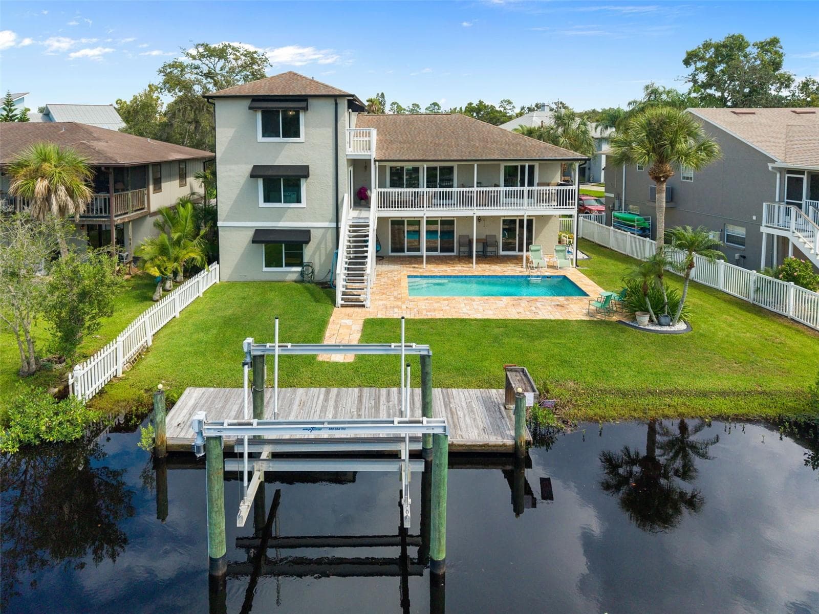 Rear view with dock and lift - 5517 TROPIC DR, NEW PORT RICHEY