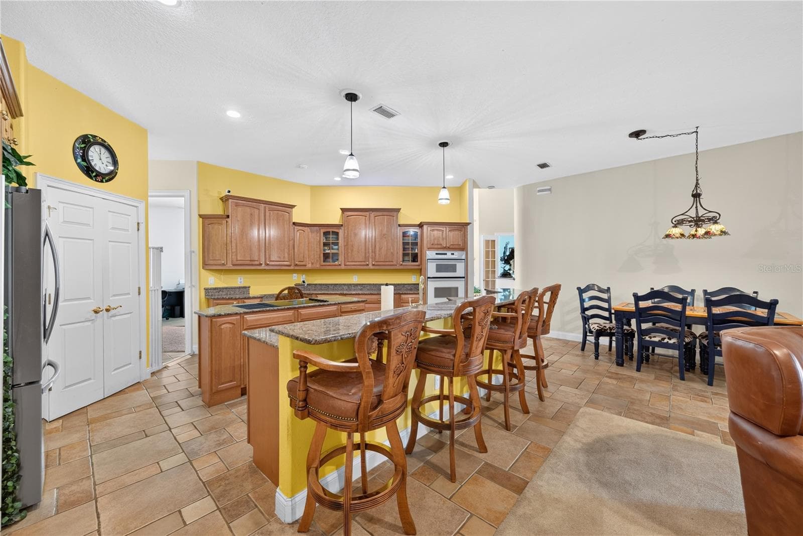 Kitchen with walk-in pantry, cooking island, bar seating and an abundance of cabinetry. - 2335 FOREST CLUB DR, ORLANDO