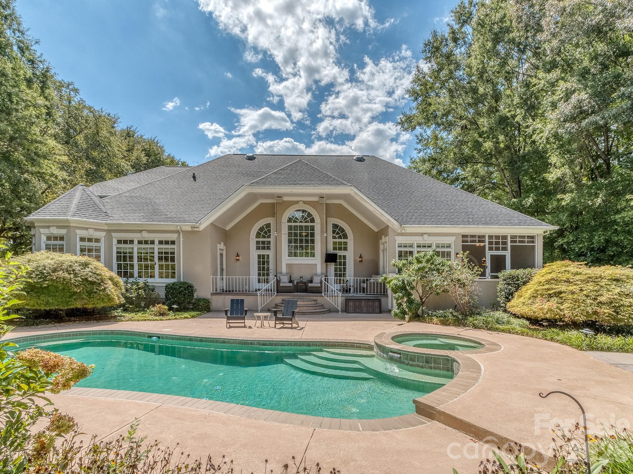 Outdoor oasis with outdoor kitchen and in-ground fire pit with built in seating. - 1733 White Pond Lane, Waxhaw