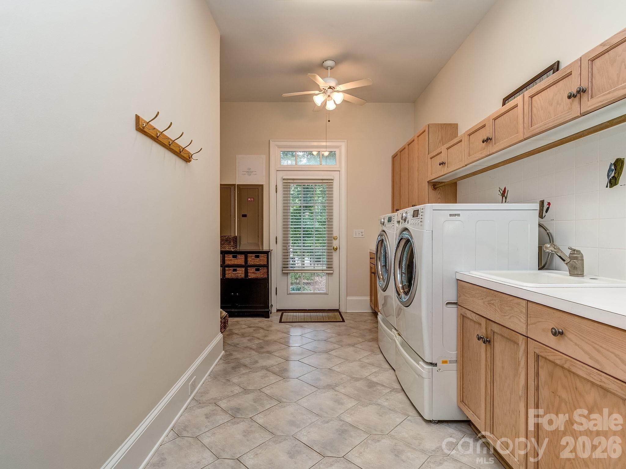 Laundry room on main floor with sink - 1733 White Pond Lane, Waxhaw