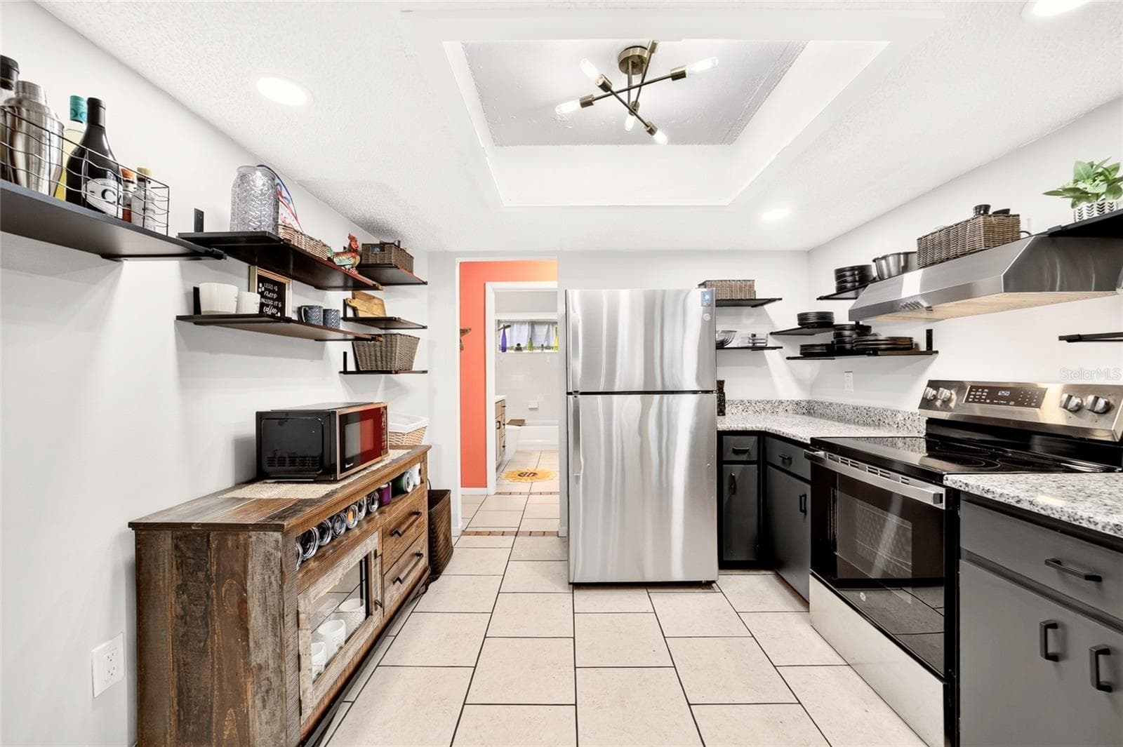 Keep it minimalist or room to add more cabinets. This functional kitchen has more storage than you notice. Keeping it airy and inviting. Lots of extra light with new LEDs in the ceiling - 9282 SW 109TH LN, OCALA