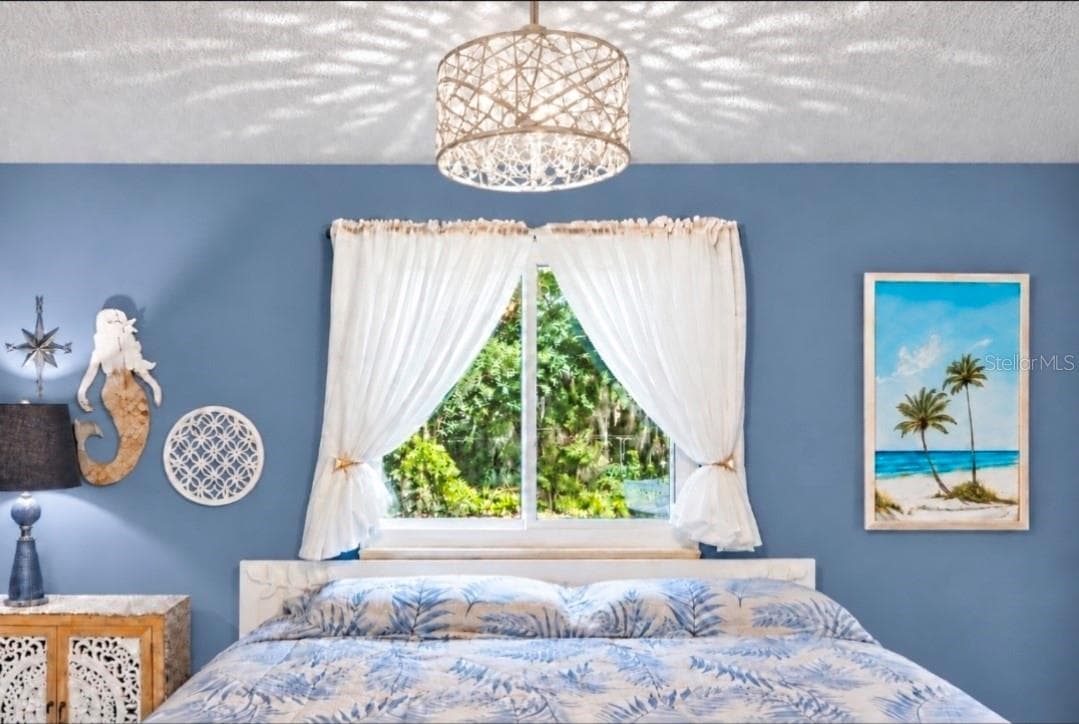 Your outside view and chandelier sparkles with luxury vibe and modern style. - 9282 SW 109TH LN, OCALA