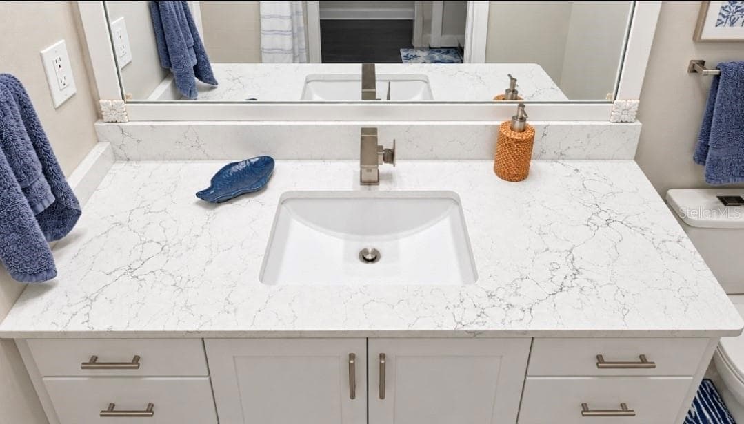 Quartz completes this look. modern sink, modern faucet and ergo height vanity - 9282 SW 109TH LN, OCALA