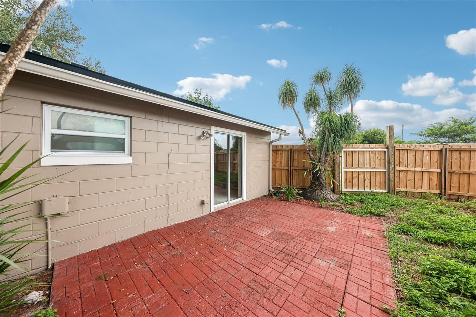 Sliding glass doors off the primary suite open to a brick paver patio. - 6698 RIVO ALTO AVE, ORLANDO