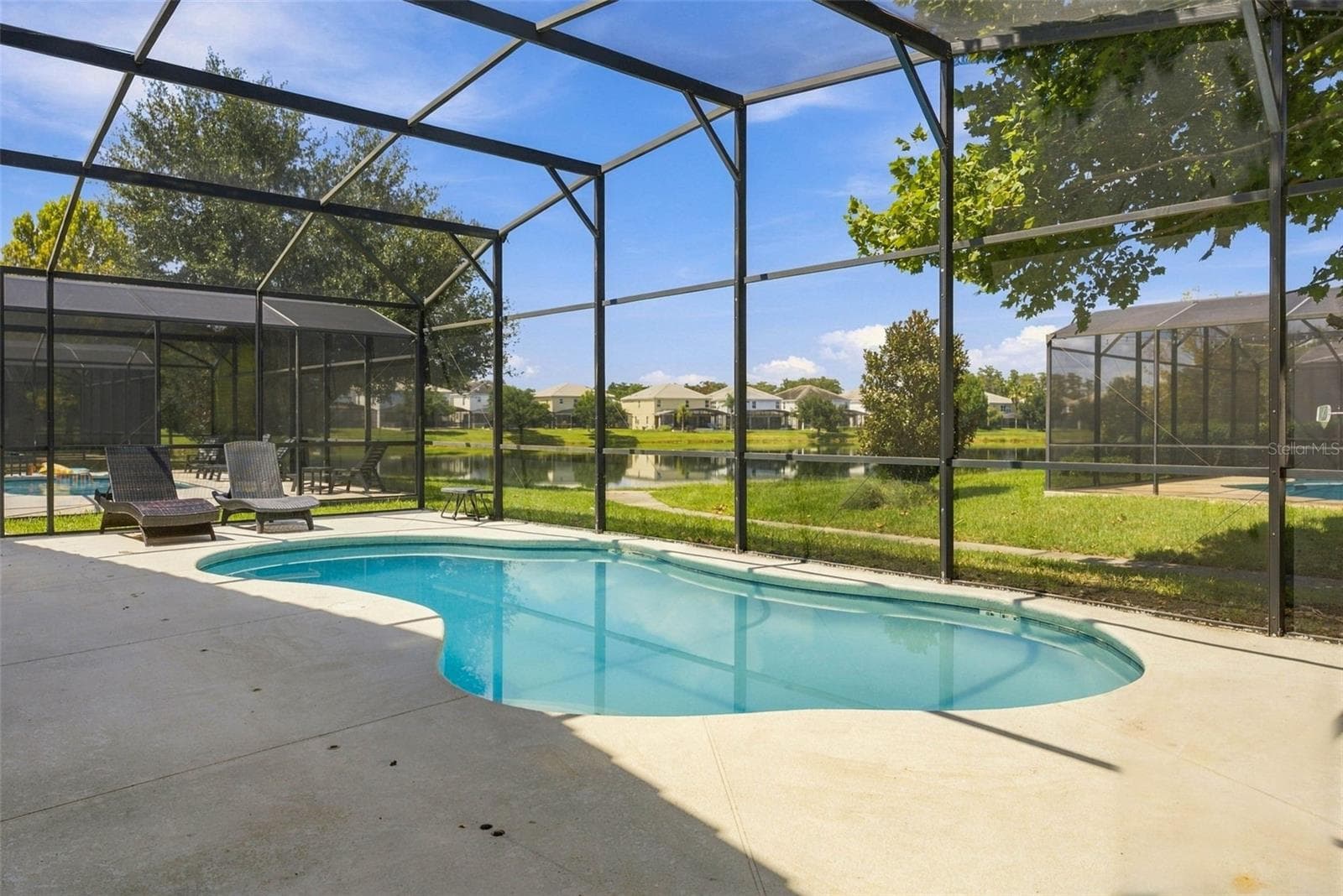 Screened-in sparkling pool overlooking the pond. - 337 MARCELLO BLVD, KISSIMMEE