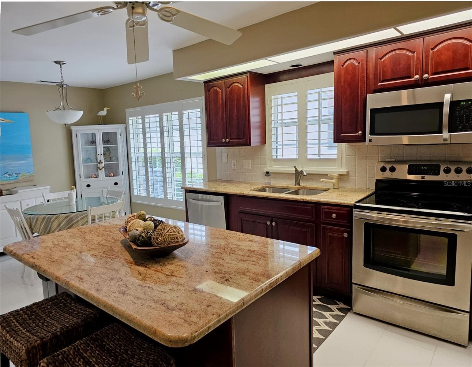 large eat-in-kitchen with ample granite countertops, center island and SS Appliances - 8351 CREEKVIEW LN, ENGLEWOOD