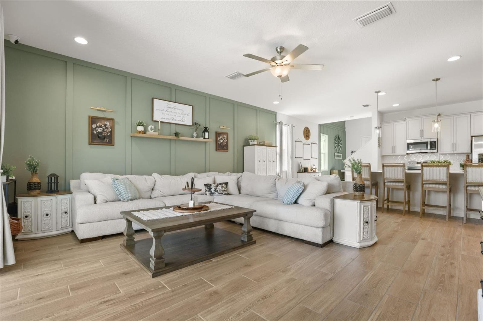 Bright, open-concept living area with ceramic tile flooring and an easy flow into the kitchen and dining space. - 7104 DILLY LAKE AVE, GROVELAND