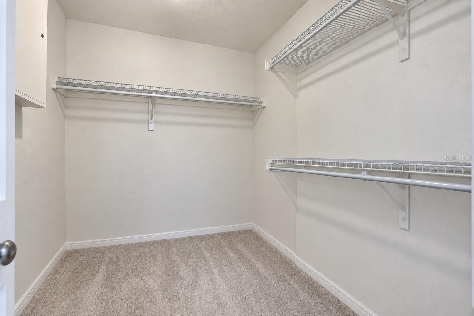 Spacious walk-in closet with plenty of shelving and storage space. - 7104 DILLY LAKE AVE, GROVELAND