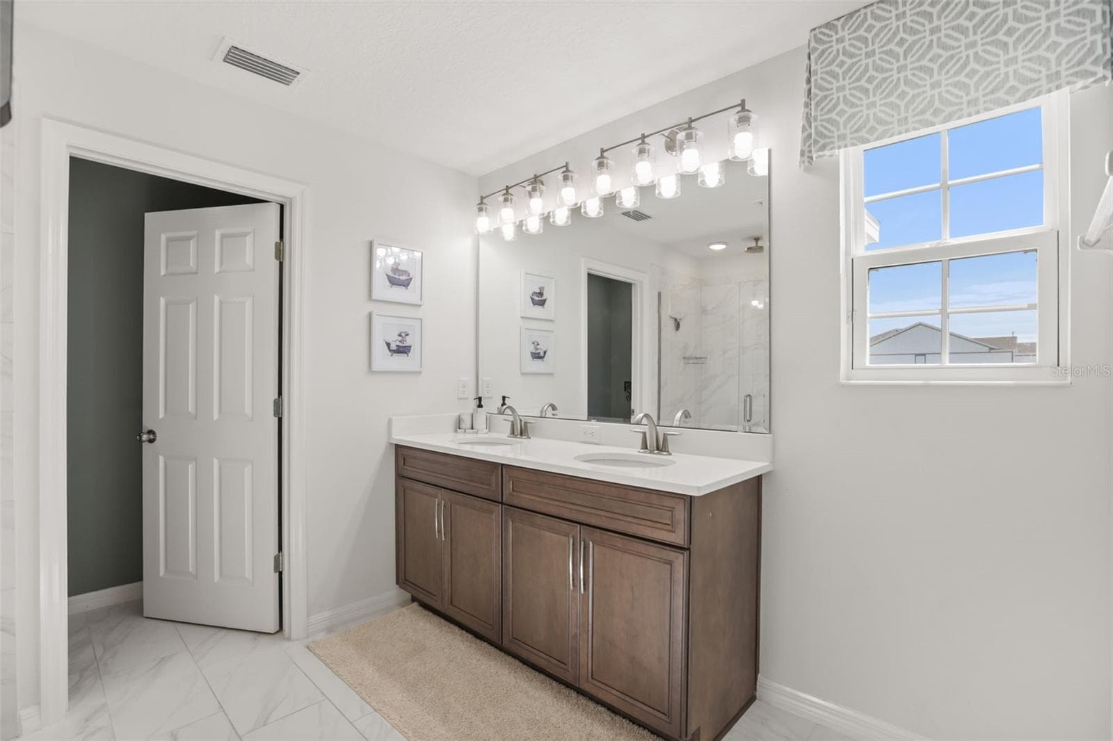 Primary bathroom with dual sinks, generous counter space. - 7104 DILLY LAKE AVE, GROVELAND