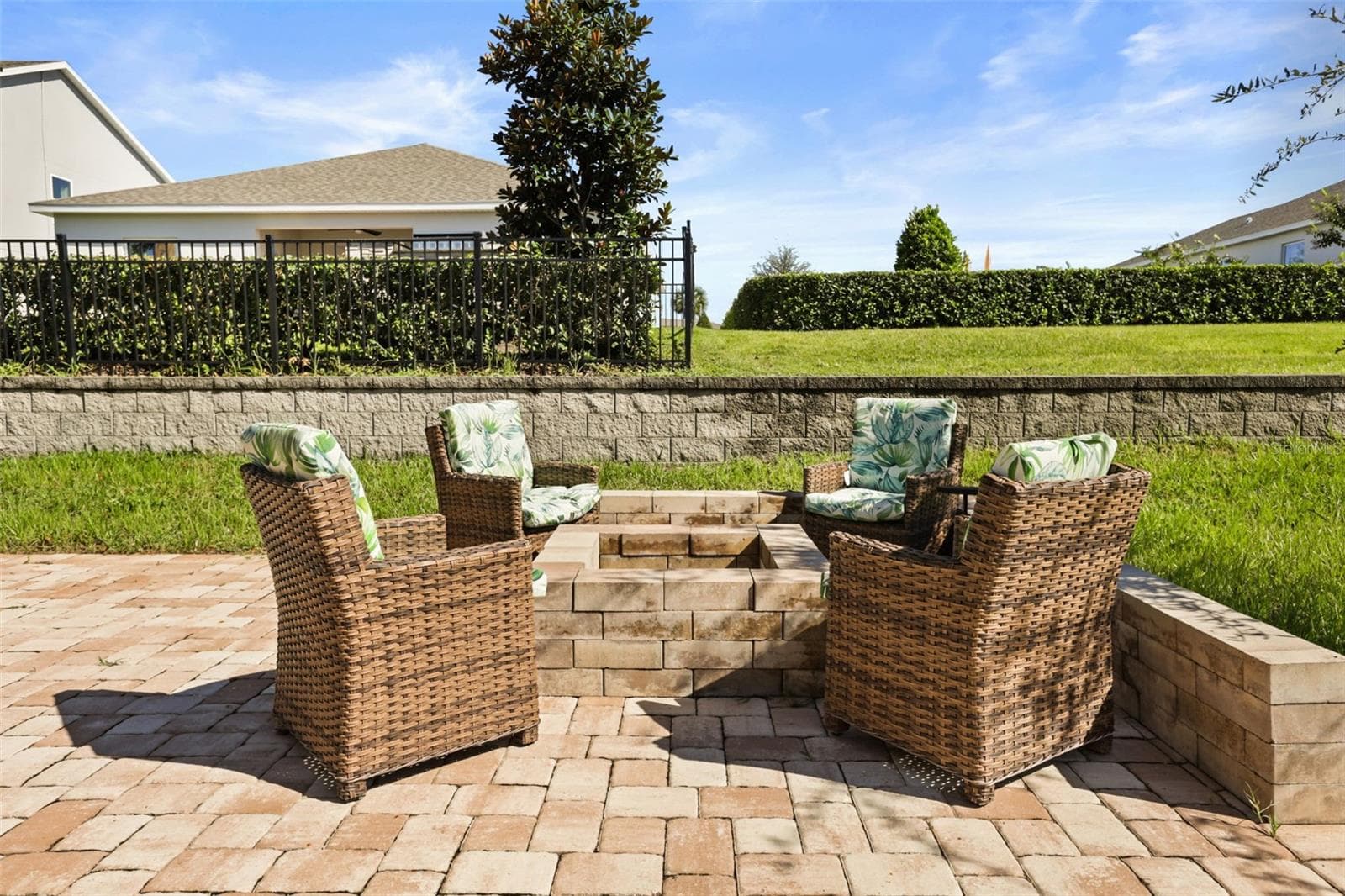 Built-in fire pit with outdoor seating area. - 7104 DILLY LAKE AVE, GROVELAND