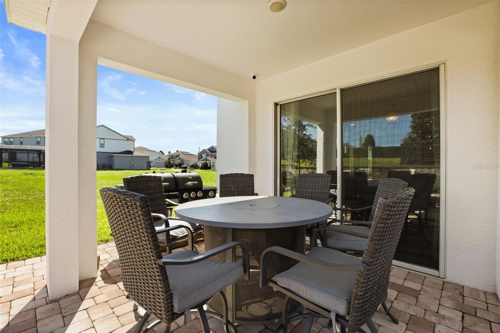 Covered rear porch with paver flooring and plenty of space for outdoor dining. - 7104 DILLY LAKE AVE, GROVELAND